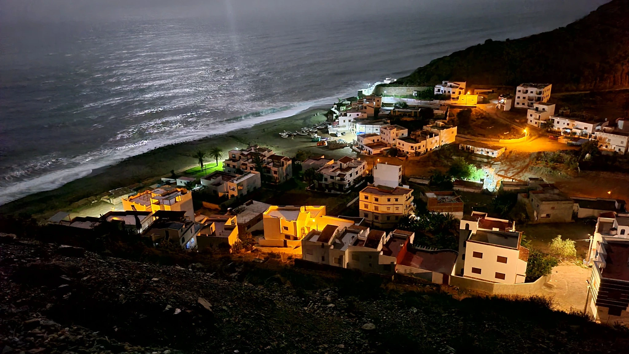Discover Jnan Nich Beach, a hidden black sand paradise in northern Morocco. Crystal clear waters, dramatic cliffs, and authentic Berber culture await.