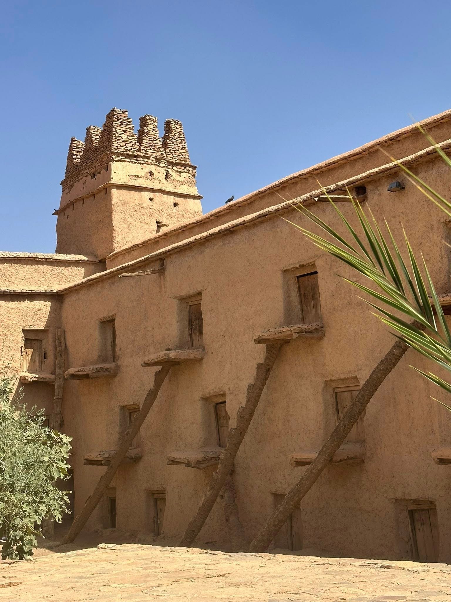 The Aït Kine collective granary is an 18th-century communal storage facility near Tata, Morocco, that serves as both a historical monument and active community center. This traditional agadir features fortress-like architecture with three levels of storage compartments around a central courtyard, built using palm tree trunks adapted to desert conditions. Beyond storage, it hosts village weddings, religious ceremonies, and gatherings, keeping Amazigh Berber traditions alive for travelers seeking authentic Moroccan heritage experiences.